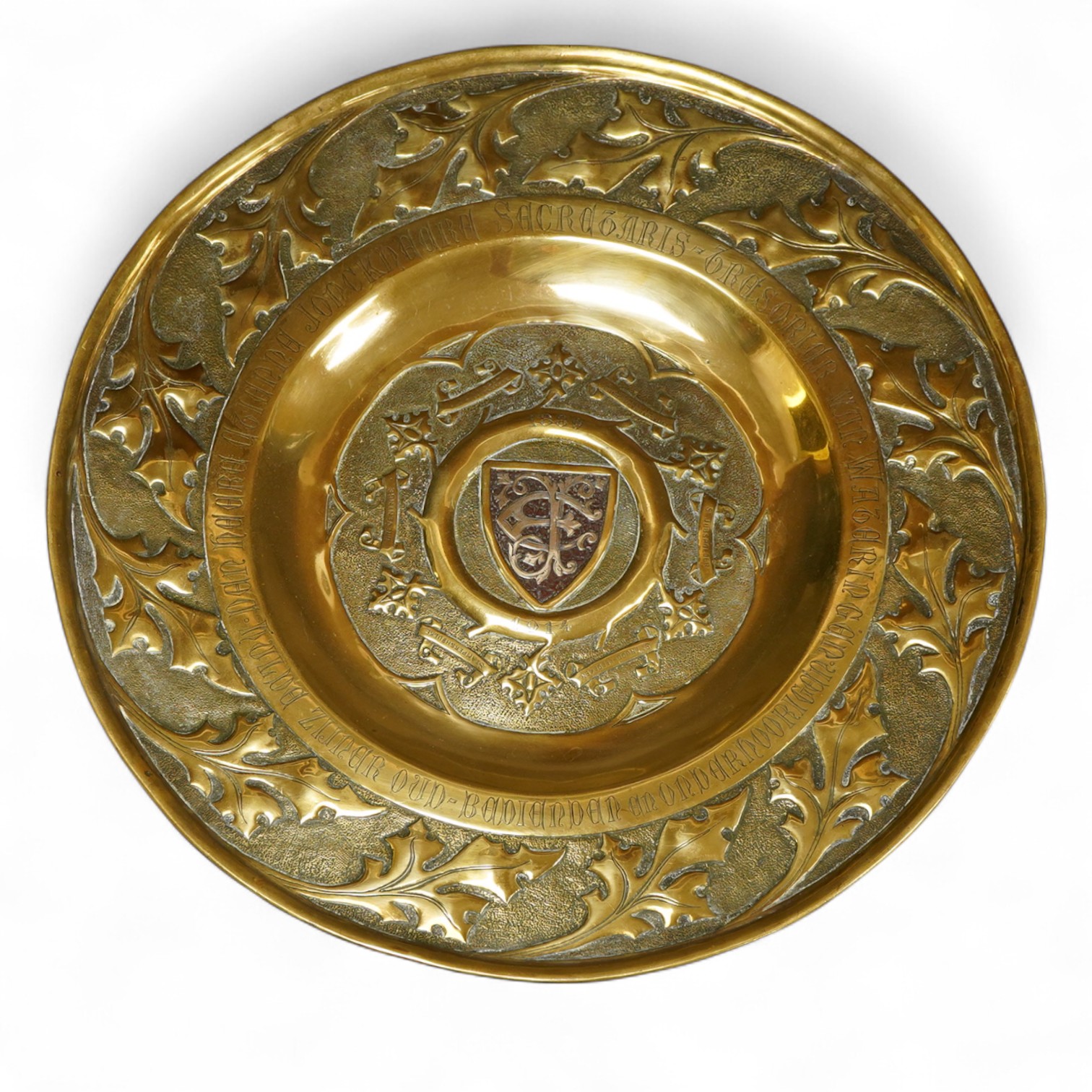 An embossed brass arts and crafts alms charger with inscriptions, 51cm in diameter